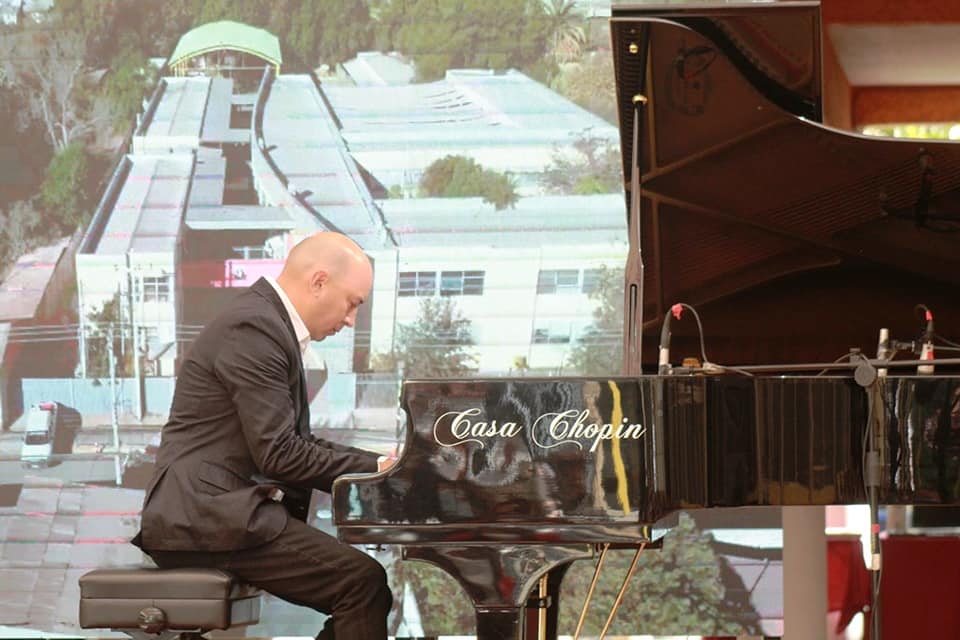 Juan Estay performing at a Casa Chopin piano on stage